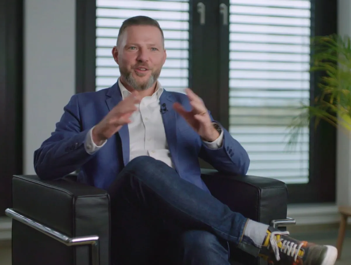man sitting in a chair being interviewed