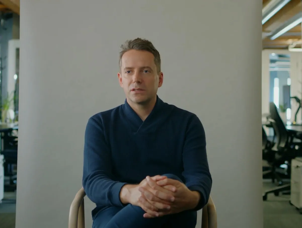 man sitting in a char being interviewed