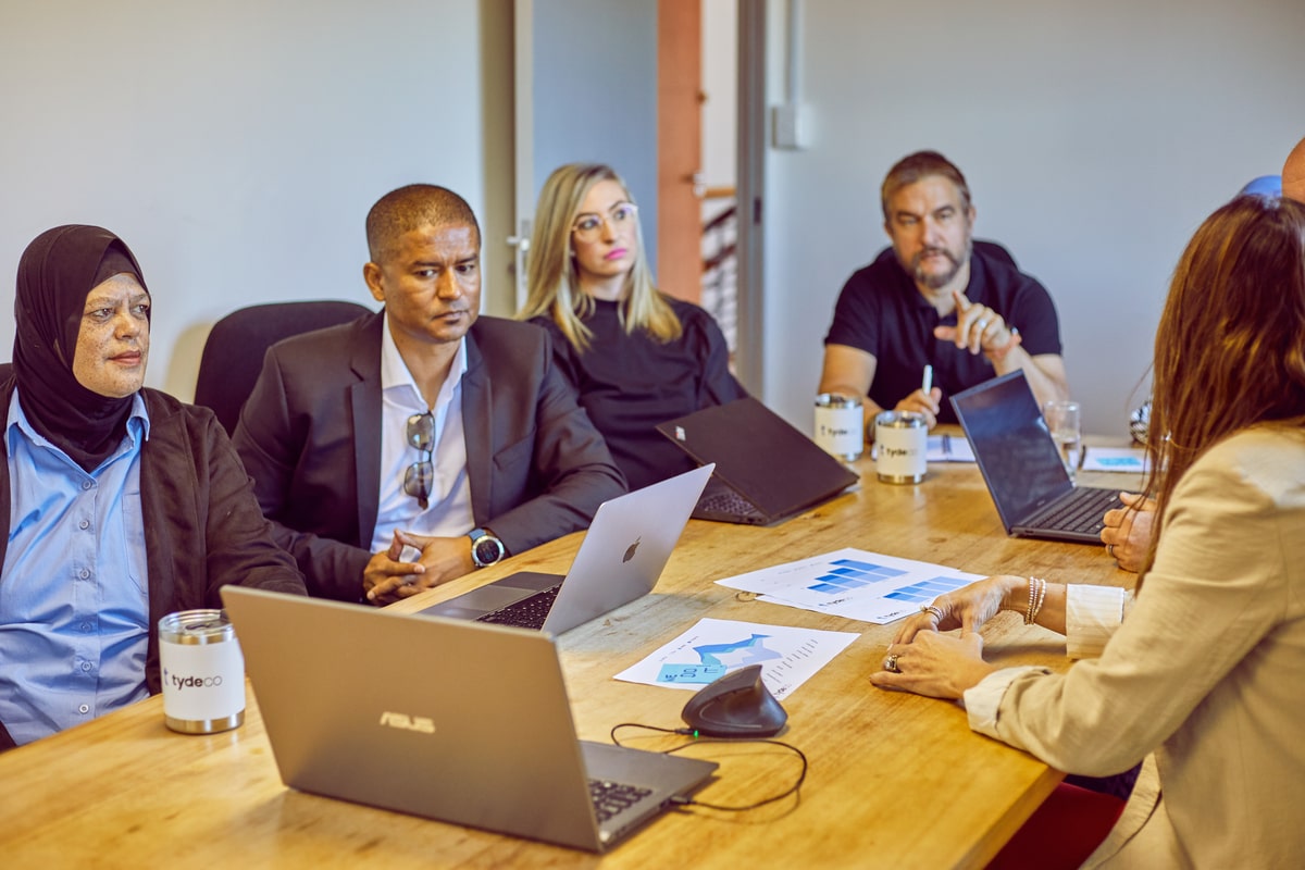 staff members in a boardroom having a meeting