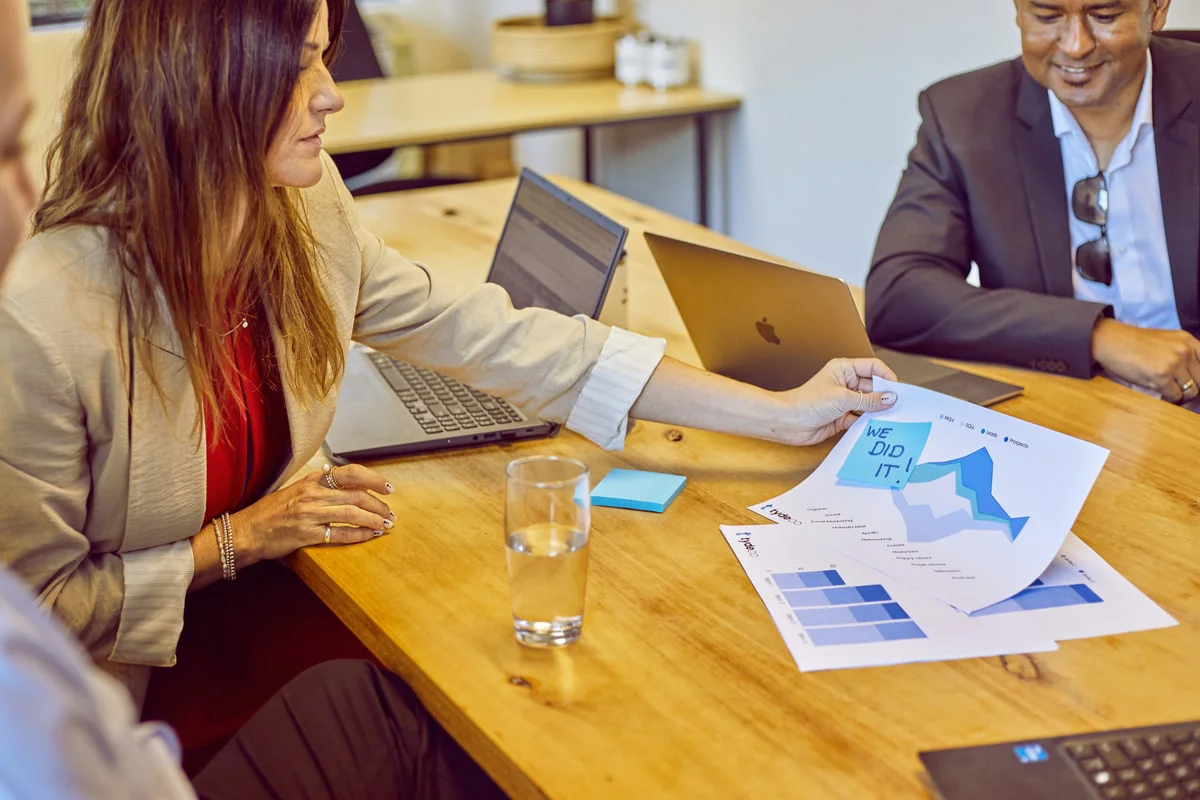 staff members having a meeting looking at graph charts