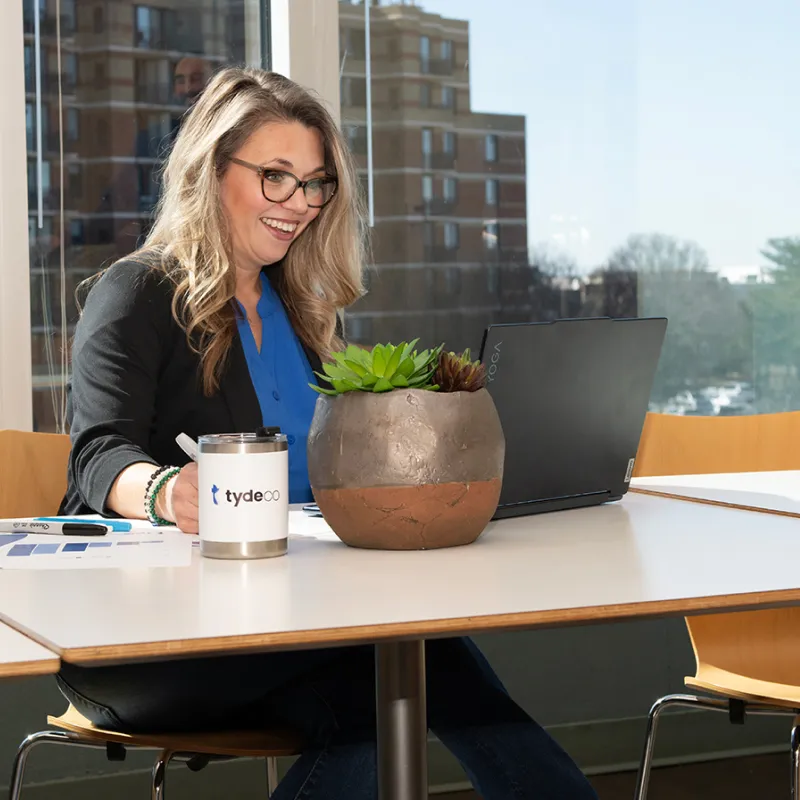 Nonprofits __ Bookkeeping_ woman sitting in front of a laptop smiling