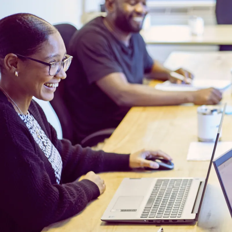 woman and a man sitting at a table laughing
