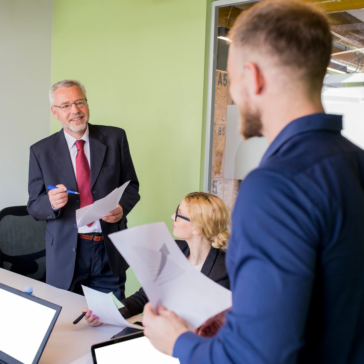 smiling-businessman-having-discussion-with-graph