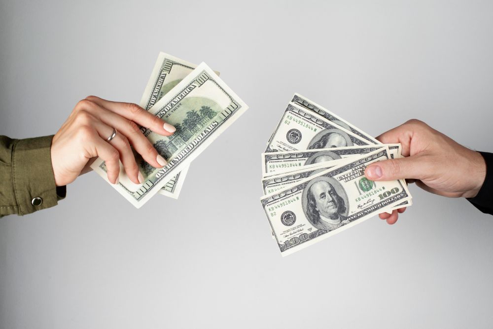 Hands exchanging money representing a legal transaction