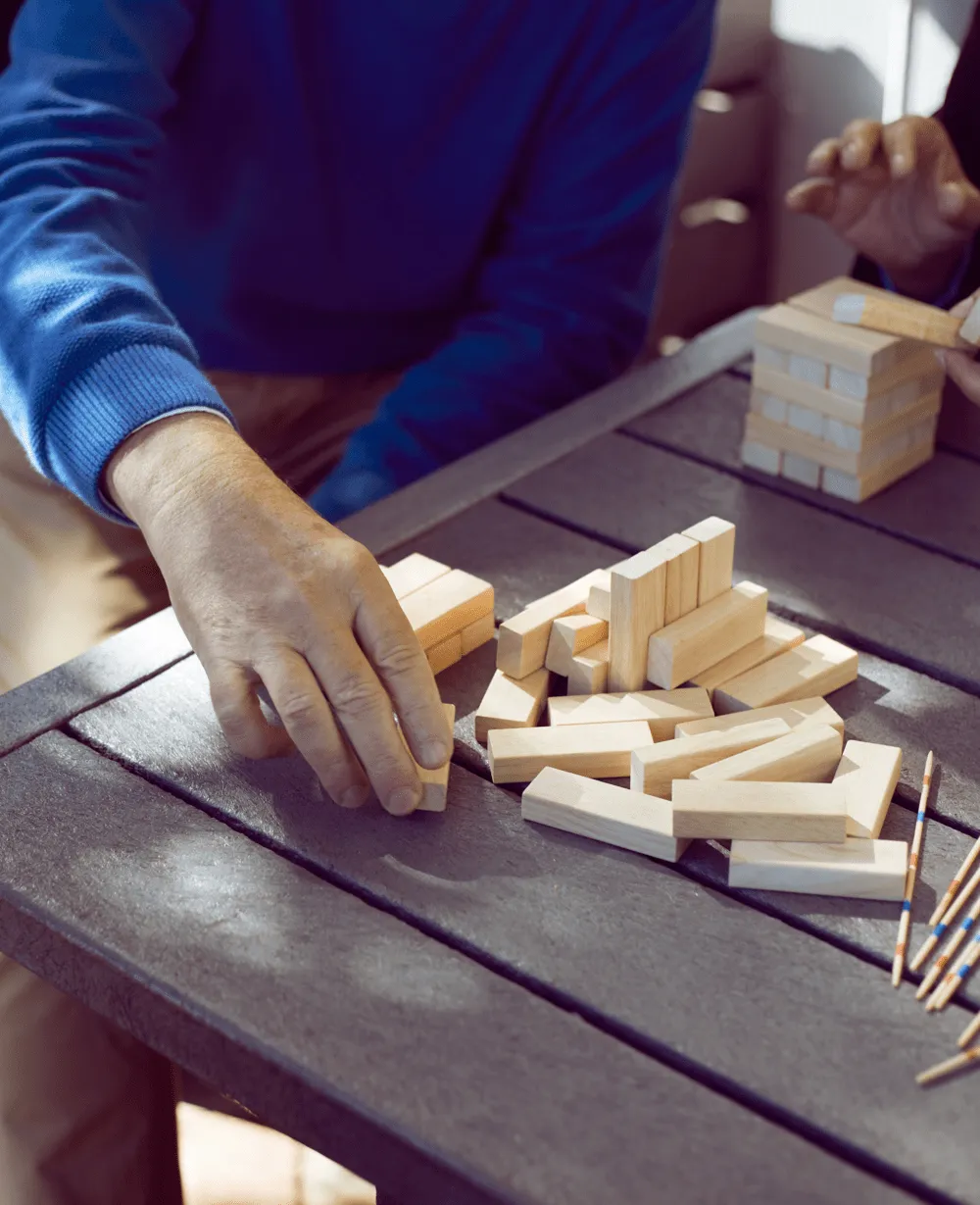 man hand building stack of wooden blocks