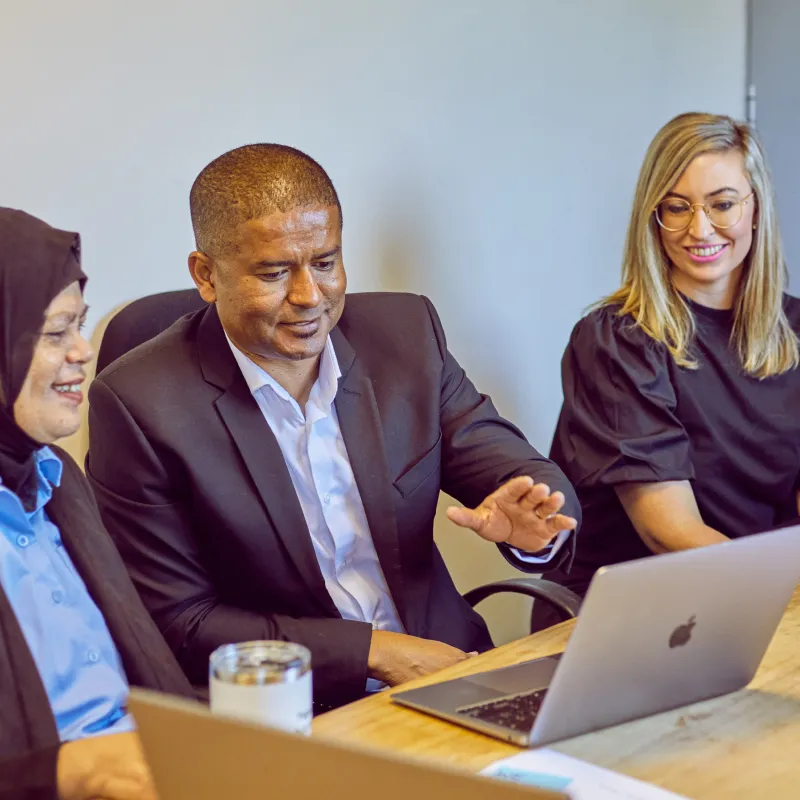 staff having a meeting looking at a laptop