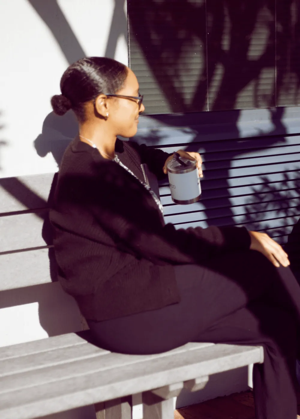 woman sitting outside drinking coffee