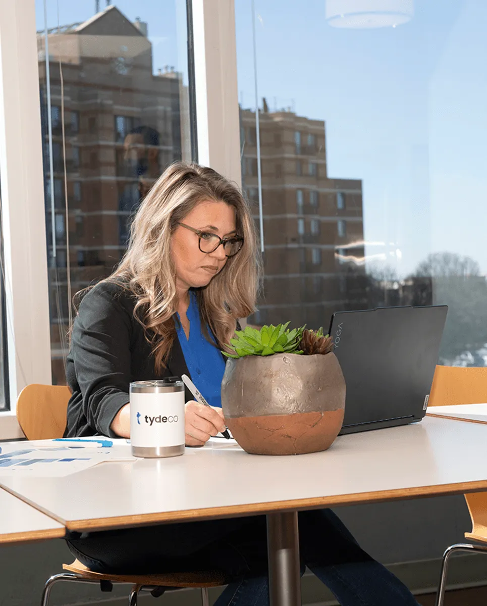 woman sitting at her desk working on her laptop