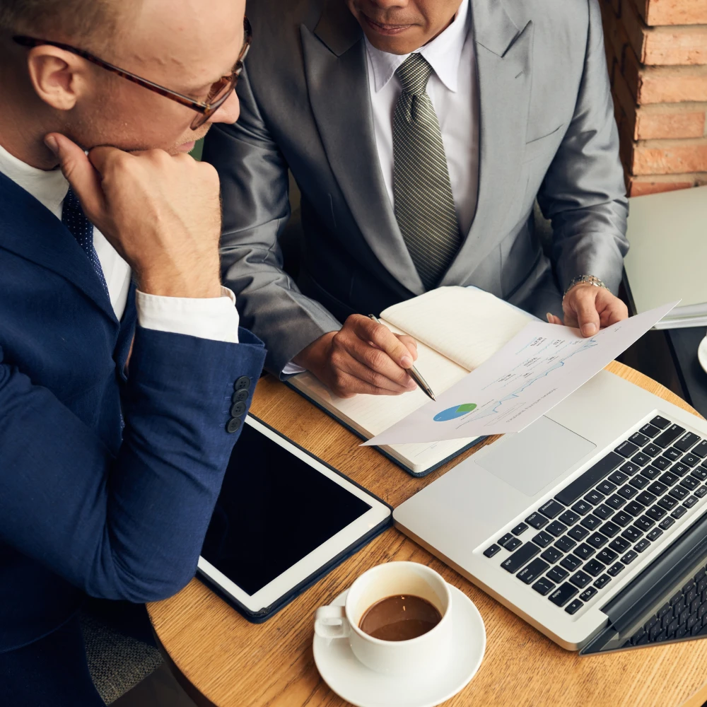 Law firm professionals reviewing accounts receivable reports and cash flow data on a laptop.