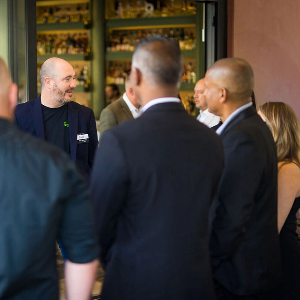 TydeCo event attendees networking and talking at an event